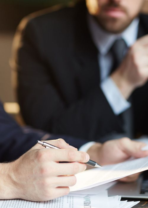 successful-business-partners-discussing-contract